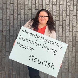 Smiling woman holding sign